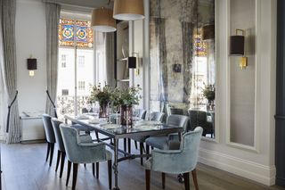 luxury dining room with large foxed mirror