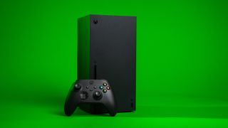 A back Xbox and Xbox controller against a bright green background