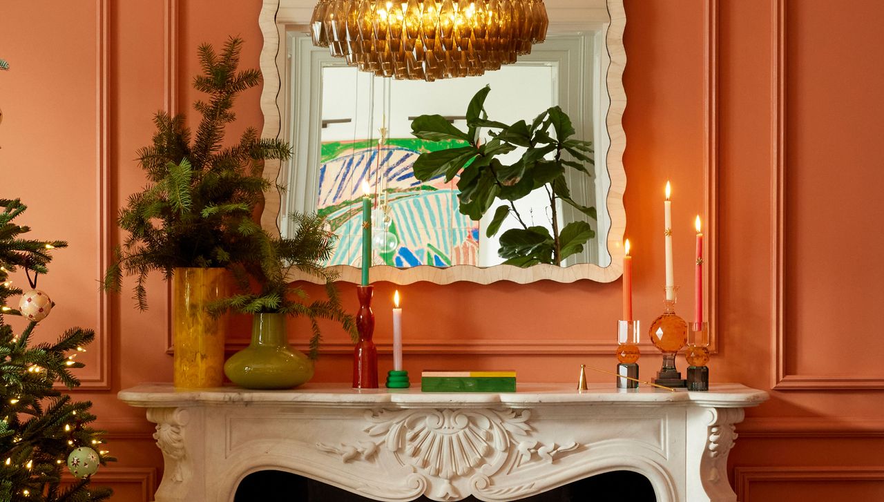 an orange room with a fireplace decorated for christmas