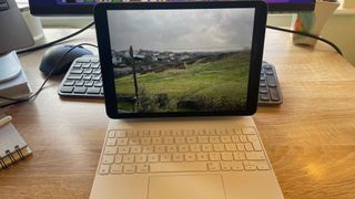 the iPad Air (2022) on a desk with a picture of a rainy landscape on the screen