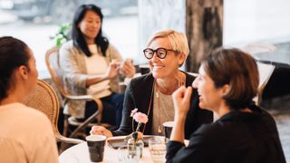 Woman smiling at a table