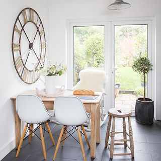 kitchen dining area with chairs and clock