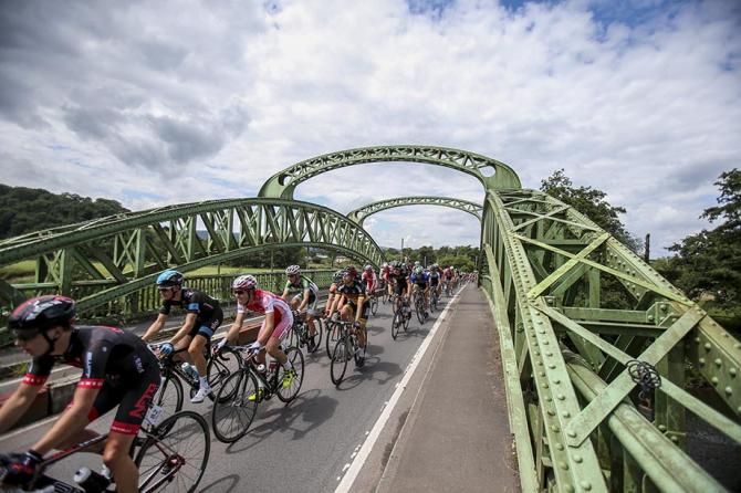 The peloton in full swing as they cross the Usk River.