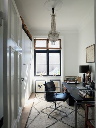 Small home office with black furniture and large berber rug
