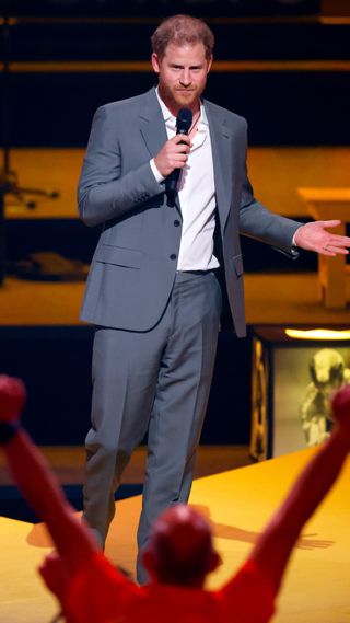 Prince Harry wearing a suit on stage