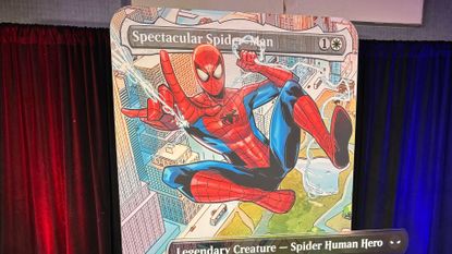 MTG Spider-Man oversized Spectacular Spider-Man card against a curtain with blue and red lighting