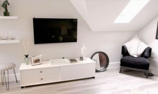 attic room with white walls and white cabinet