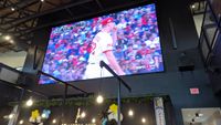 Images from Ohio's Liberty Collective, with baseball games showing and people enjoying the outdoor breezeway. 
