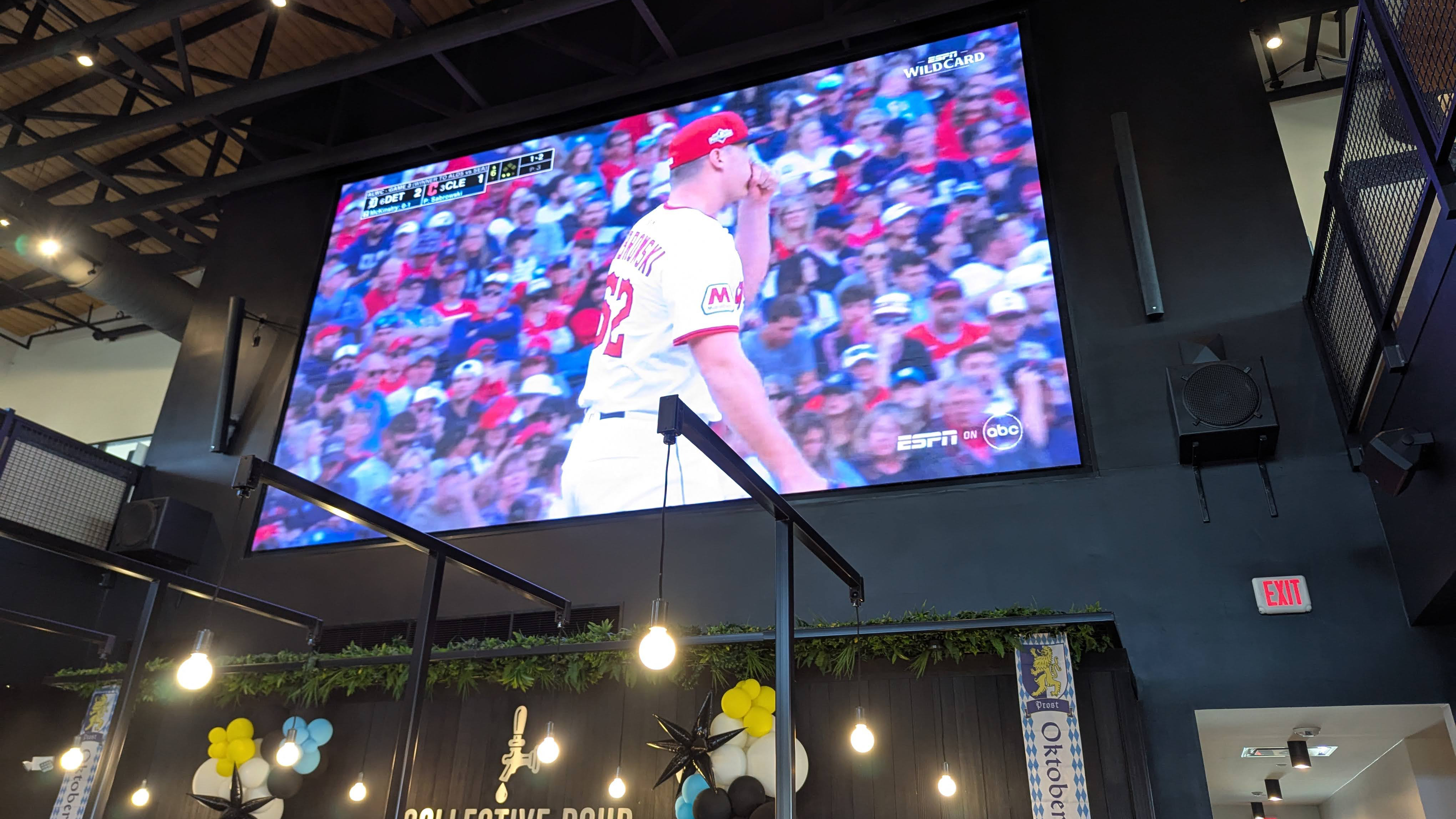 Images from Ohio's Liberty Collective, with baseball games showing and people enjoying the outdoor breezeway. 