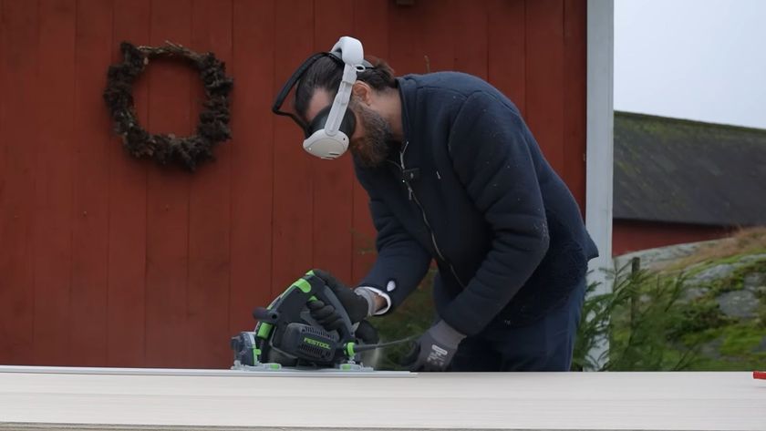 A still from a YouTube video showing The Swedish Maker cutting a piece of wood with power tools while wearing a Meta Quest 3 VR headset.