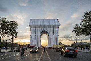 A photo of the Arc de Triomphe covered in a silvery blue sheet.