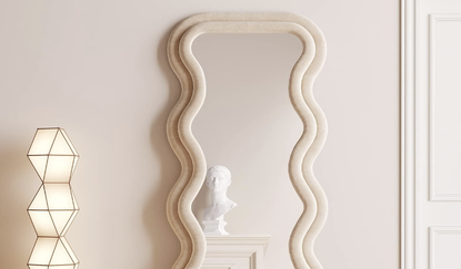 wavy full length mirror against a grey wall