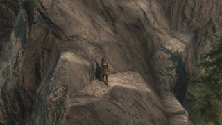 Best Skyrim mods - a character pauses in the middle of their climb up a Skyrim rock face.