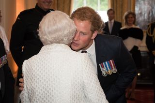 Prince Harry kisses his grandmother Queen Elizabeth on the cheek
