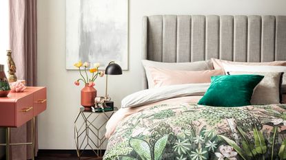 bed with grey headboard and patterned bedsheets