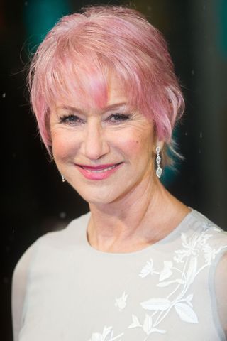 Helen Mirren is pictured with a pink pixie haircut whilst attending the EE British Academy Film Awards at The Royal Opera House on February 10, 2013 in London, England.