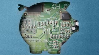 A cutout of a pig, to represent banking, on top of a circuit board