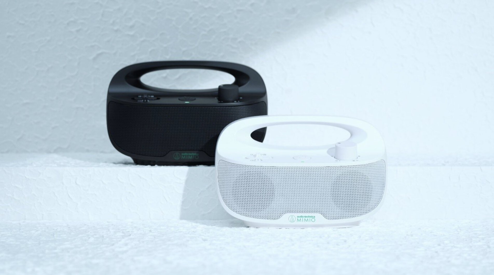 Two Mimio Sound Move speakers, on gray background