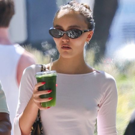 Lily-Rose Depp styled blue ballet flats with a white long-sleeve and black capri pants