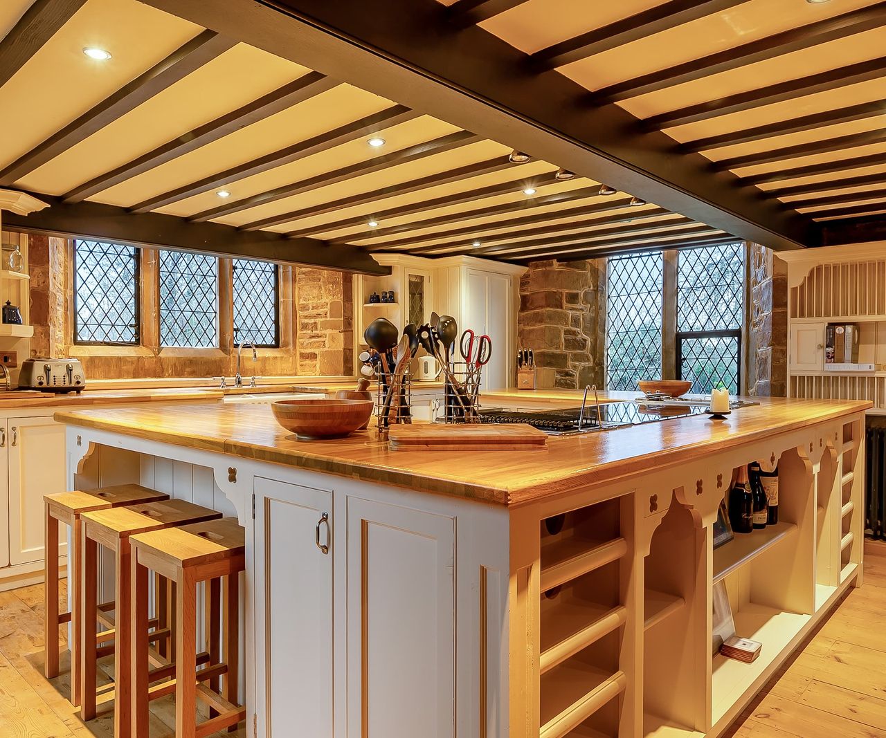 A white kitchen island wooden surface and white cabinets