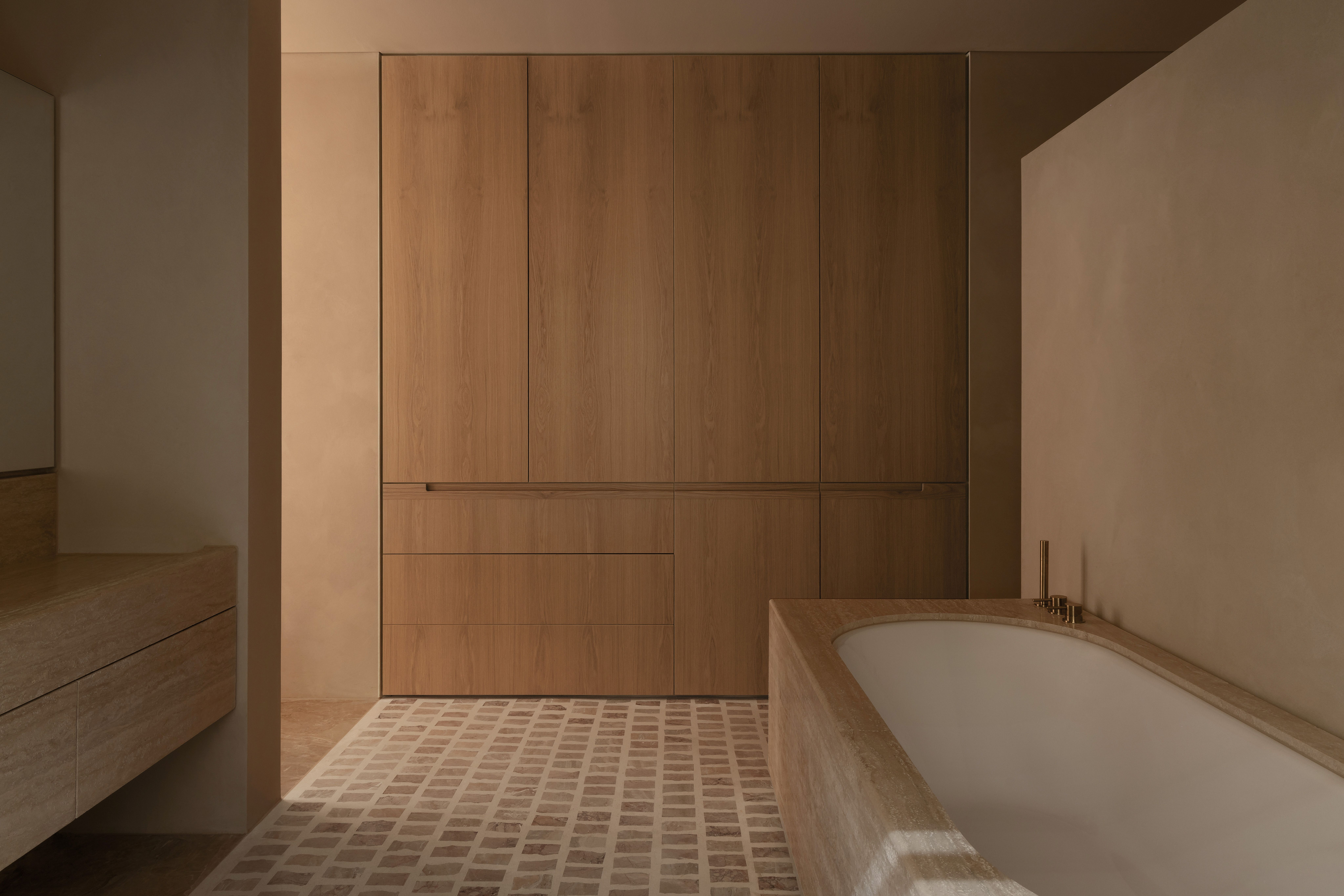 Minimalist neutral bathroom with wooden storage doors