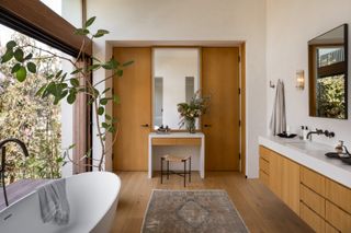 A bathroom with a tall plant
