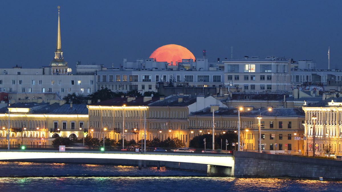 The full moon rises over the city of St Petersburg, Russia, on Aug. 21, 2021.