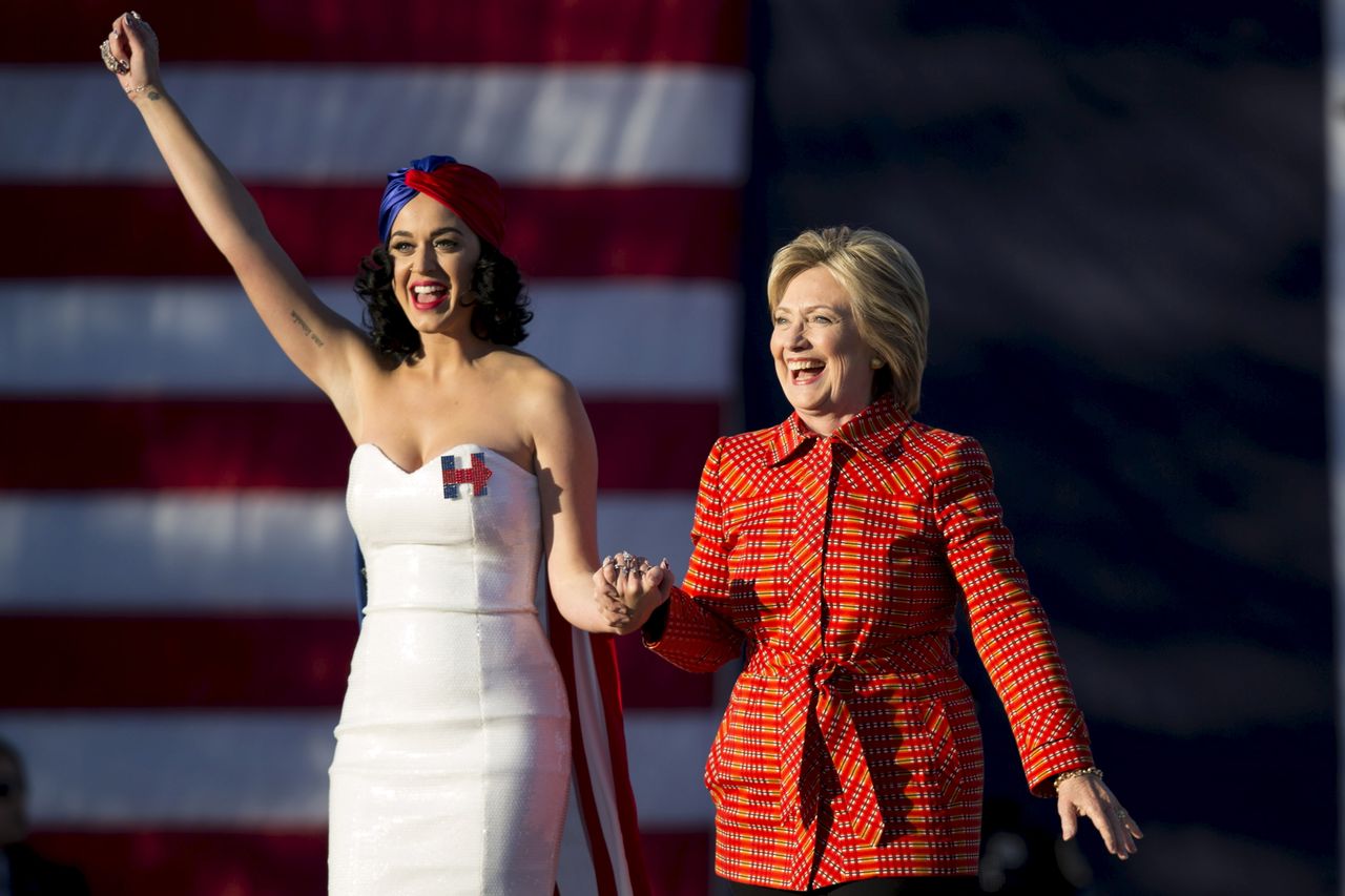 Hillary Clinton arrives with singer Katy Perry during a campaign rally in Des Moines, Iowa, Oct. 24, 2015.