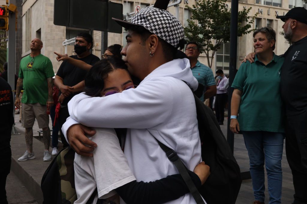 Couple hugging on the street.