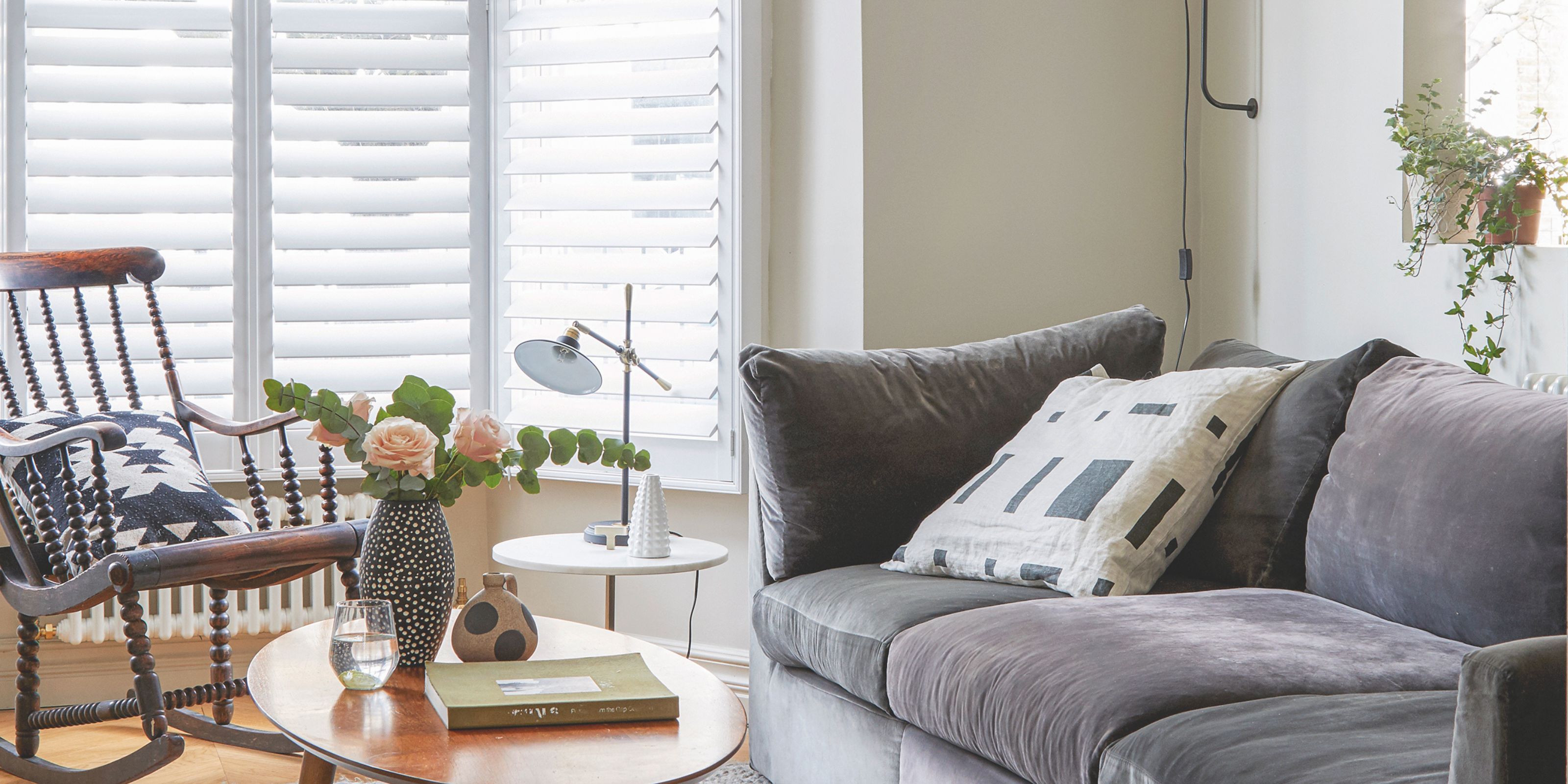 A neutral living room scheme with shutter blinds slanted shut