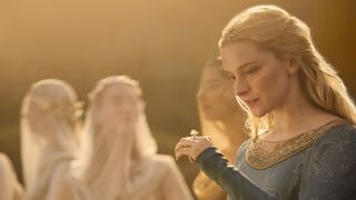 Galadriel looks down at Nenya in a sunlit space in The Rings of Power season 2