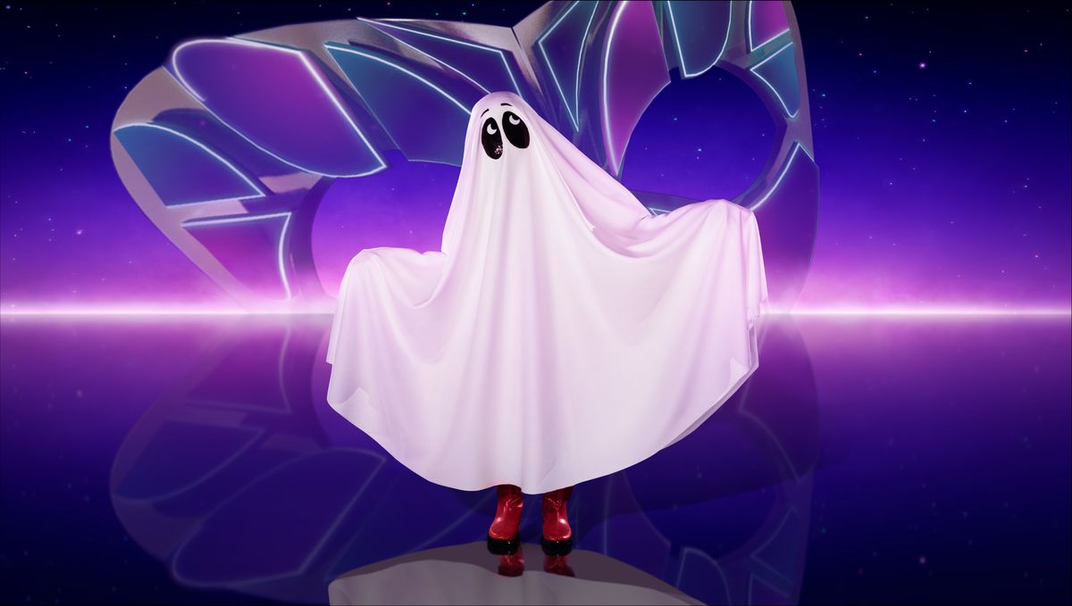 A promo shot of Ghost from The Masked Singer - a classic &#039;draped sheet&#039; style of ghost costume with big black ovals for eyes