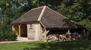 Car port with wood store