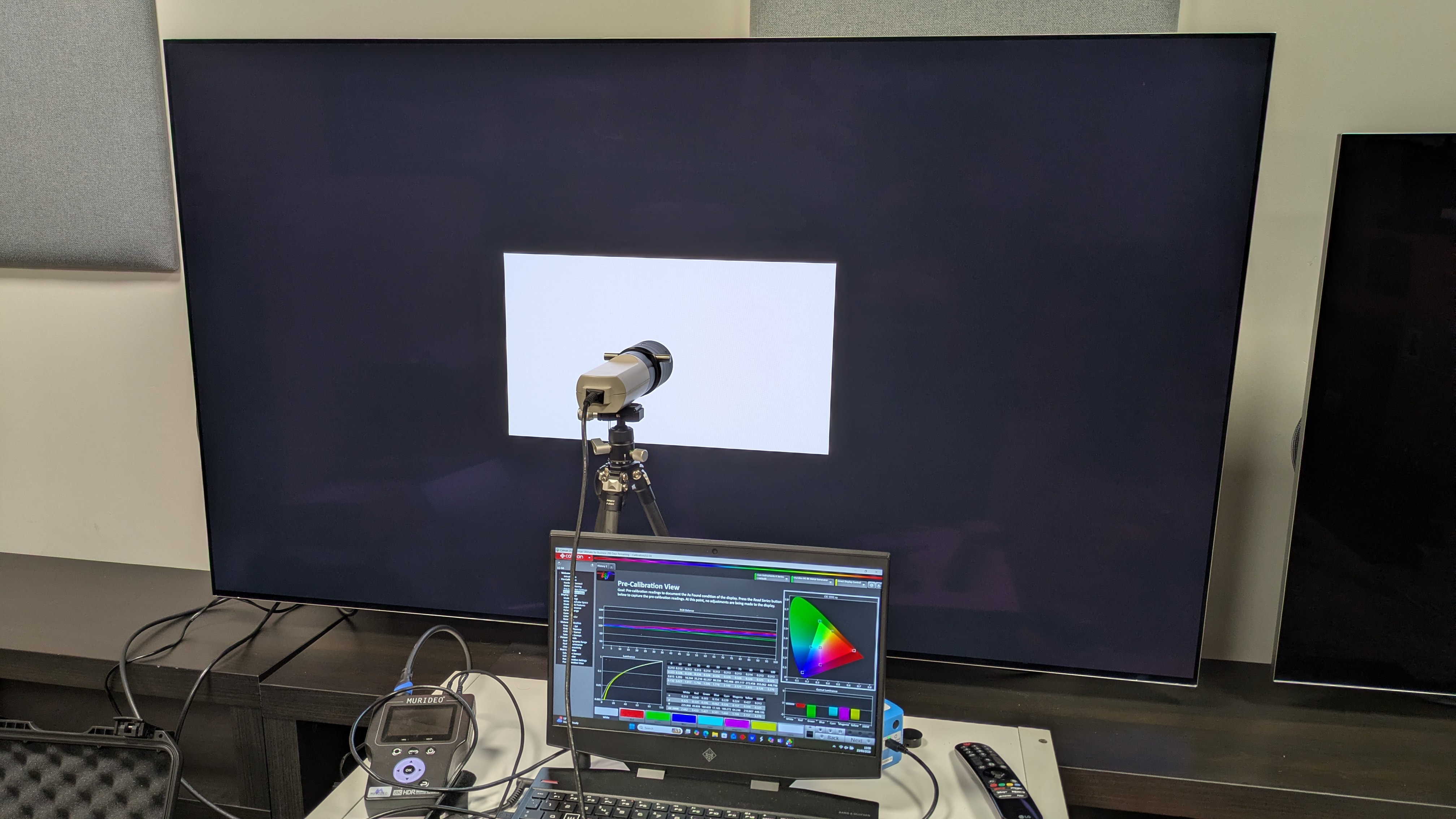 LG G6 OLED TV with colorimeter, test pattern generator and laptop with Portrait Displays Calman software attached. White window test pattern is on G6 screen