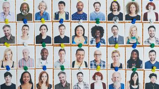 Grid of multi-ethnic headshot portraits pinned to cork board