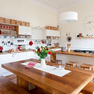 kitchen with cream wall wooden table and stools