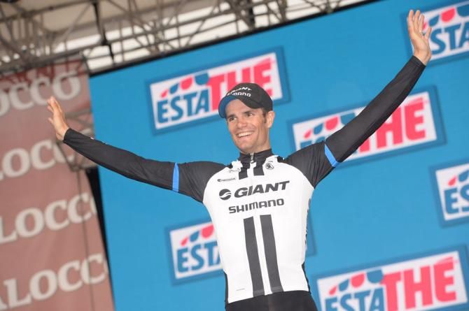 Luka Mezgec steps onto the podium, after winning his first Grand Tour stage
