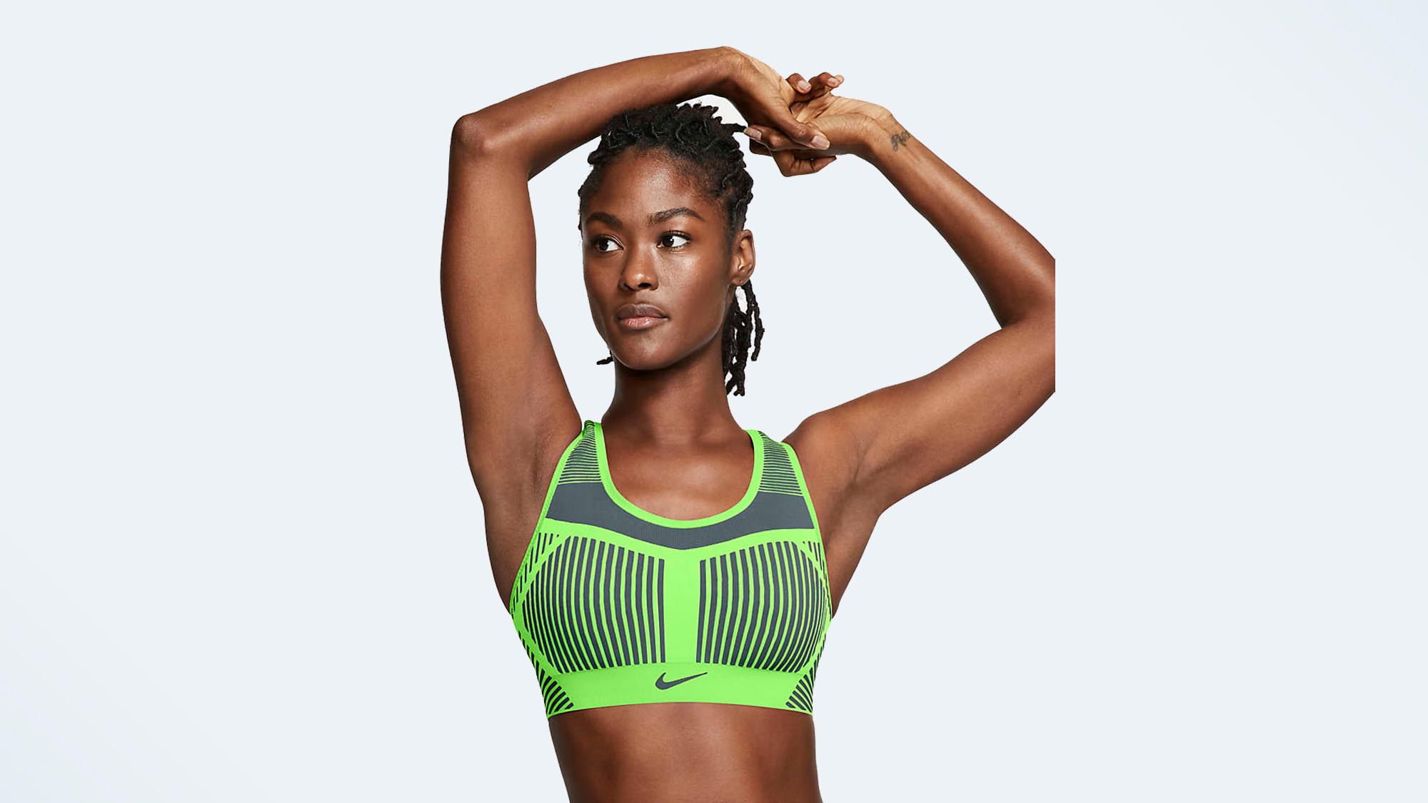 A photo of a woman wearing the Nike FE/OM sports bra, one of the best high-impact sports bras