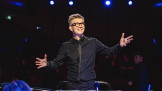 Gareth Malone in a black shirt and tie conducts a choir in Gareth Malone's Easter Passion.