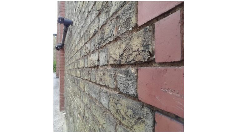 Looking along a brick wall