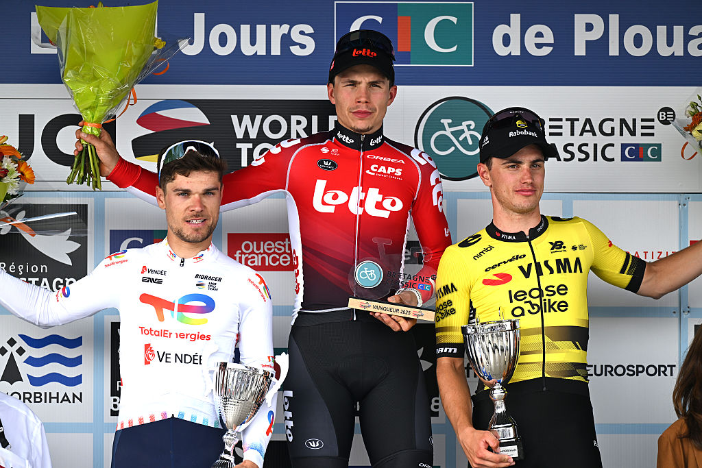 PLOUAY, FRANCE - AUGUST 31: (L-R) Emilien Jeanniere of France and Team TotalEnergies on second place, race winner Arnaud De Lie of Belgium and Team Lotto and Olav Kooij of Netherlands and Team Visma | Lease a Bike on third place pose on the podium ceremony after the 89th Bretagne Classic - Ouest-France 2025 a 261.7km stage from Plouay to Plouay / #UCIWT / on August 31, 2025 in Plouay, France. (Photo by Luc Claessen/Getty Images)