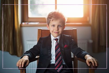 Smiling little boy wearing a suit and tie