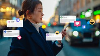 A woman scrolls through social media messages on her smartphone.