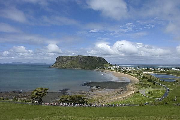 The peloton string out in the foreground with Stanley's famous landmark the 'Nut' in the background.