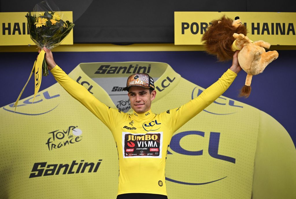 JumboVisma teams Belgian rider Wout Van Aert wearing the overall leaders yellow jersey celebrates on the podium after the 5th stage of the 109th edition of the Tour de France cycling race 1537 km between Lille and Arenberg Porte du Hainaut in northern France on July 6 2022 Photo by Marco BERTORELLO AFP Photo by MARCO BERTORELLOAFP via Getty Images