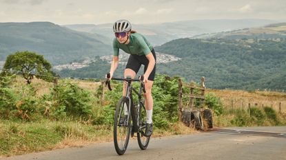 Image shows Anna cycling in 100% sunglasses