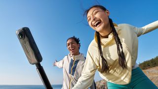 Insta360 X5 in hands of 2 users