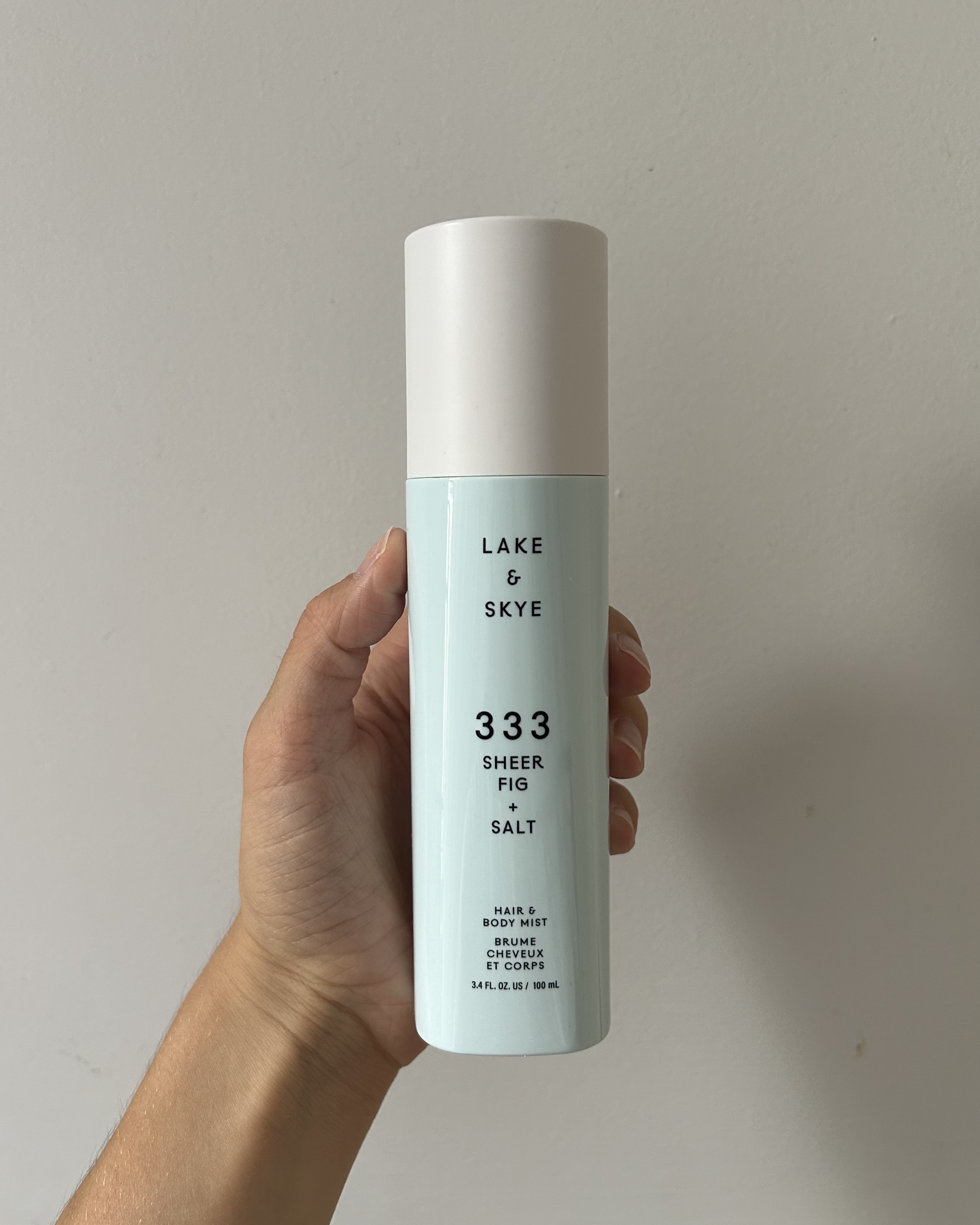 Alyssa Brascia holding the Lake & Skye 333 Sheer Fig + Salt Hair & Body Mist.