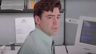 Ron Livingston sits in his cubicle looking worried in Office Space.