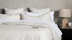 A modern, minimalist bedroom with cream and white bedding from Riley Home.